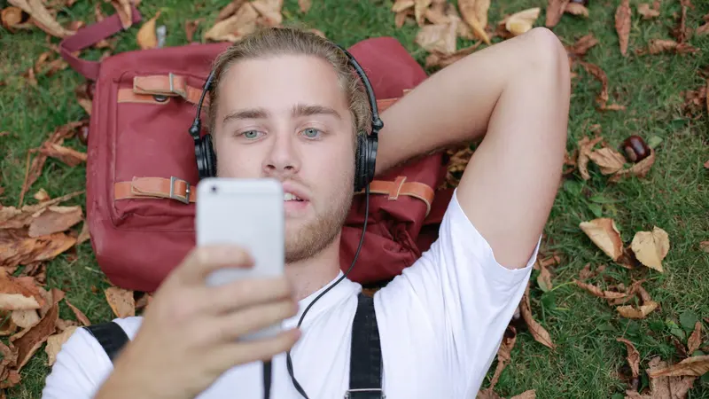 Jeune homme au casque écoutant de la musique sur son téléphone